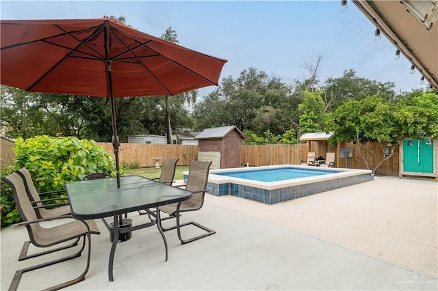 605 W Lozano St, Harlingen, TX 78550 - view of swimming pool featuring a patio, a storage shed, a fenced backyard, and outdoor dining space