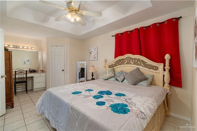 605 W Lozano St, Harlingen, TX 78550 - bedroom with a raised ceiling, tile patterned flooring, a ceiling fan, and ensuite bathroom