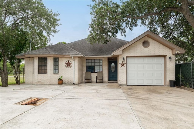 605 W Lozano St, Harlingen, TX 78550 - view of front facade featuring driveway, an attached garage, a shingled roof, and brick siding