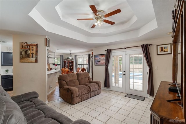 605 W Lozano St, Harlingen, TX 78550 - living room featuring a tray ceiling, light tile patterned floors, ceiling fan, and french doors