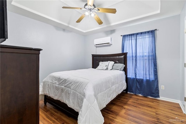 bedroom with a wall mounted AC, a raised ceiling, ceiling fan, and dark wood-type flooring