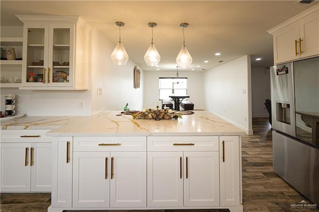 kitchen featuring dark hardwood / wood-style floors, decorative light fixtures, white cabinets, light stone counters, and stainless steel refrigerator with ice dispenser