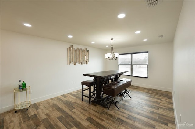 dining room featuring dark hardwood / wood-style flooring and a chandelier