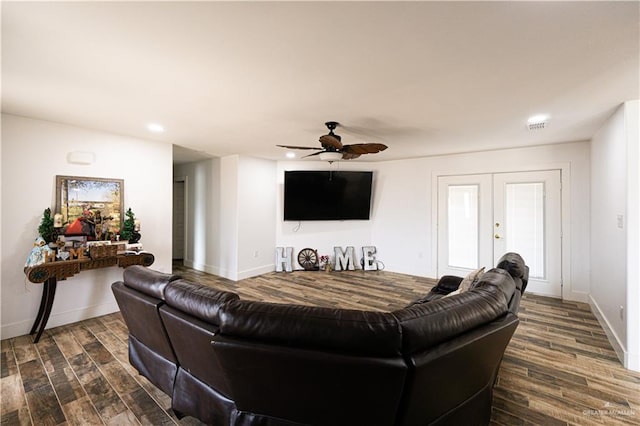 living room featuring dark hardwood / wood-style flooring, french doors, and ceiling fan