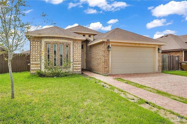 ranch-style house featuring a garage and a front lawn