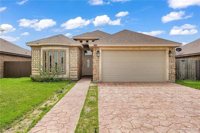 view of front of home with a garage and a front yard