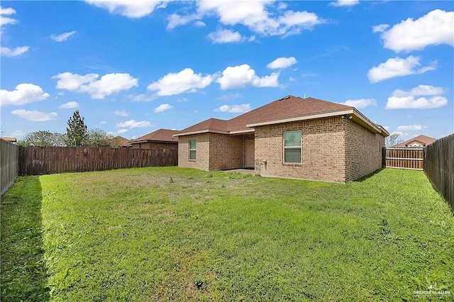 rear view of property with a yard