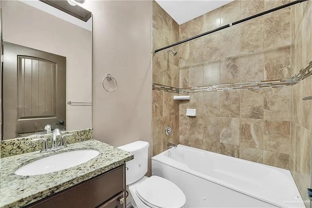 full bathroom featuring vanity, toilet, and tiled shower / bath combo