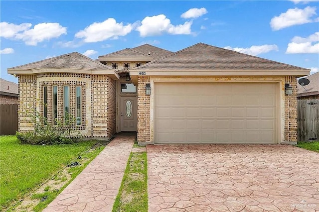 view of front of home with a garage and a front lawn