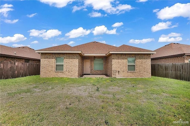 back of house featuring a yard