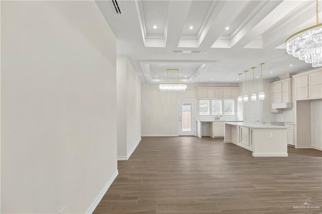 4312 Xenops Ave, Mcallen, TX 78503 - unfurnished living room featuring wood finished floors, baseboards, a chandelier, recessed lighting, and a sink