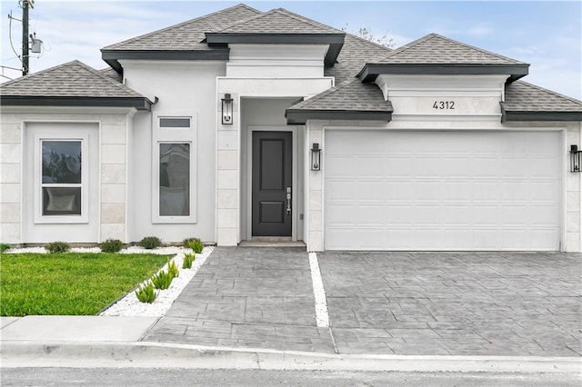 4312 Xenops Ave, Mcallen, TX 78503 - view of front of property featuring a shingled roof, a garage, decorative driveway, and stucco siding