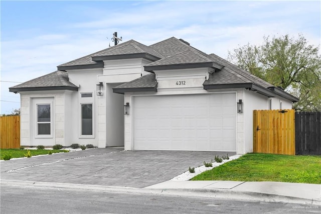 4312 Xenops Ave, Mcallen, TX 78503 - view of front of home featuring roof with shingles, an attached garage, driveway, and stucco siding