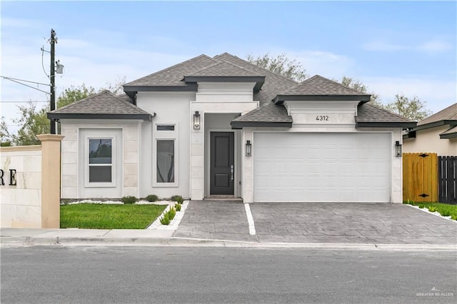 4312 Xenops Ave, Mcallen, TX 78503 - view of front facade with roof with shingles, an attached garage, stucco siding, and driveway