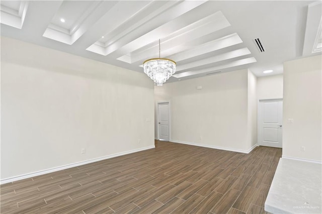 4312 Xenops Ave, Mcallen, TX 78503 - spare room featuring a chandelier, dark wood-type flooring, baseboards, a raised ceiling, and recessed lighting