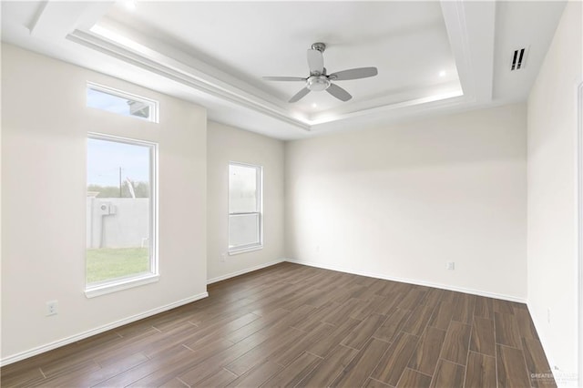 4312 Xenops Ave, Mcallen, TX 78503 - spare room with a tray ceiling, dark wood-style floors, ceiling fan, baseboards, and recessed lighting