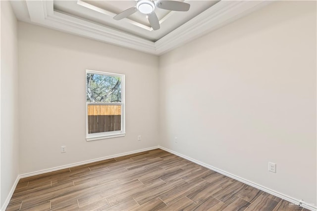 unfurnished room with a tray ceiling and ceiling fan