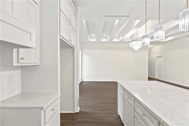 4312 Xenops Ave, Mcallen, TX 78503 - kitchen featuring wood finish floors, baseboards, decorative light fixtures, a chandelier, and white cabinetry