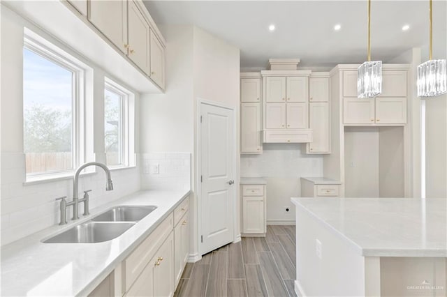 4312 Xenops Ave, Mcallen, TX 78503 - kitchen with a sink, tasteful backsplash, recessed lighting, hanging light fixtures, and light wood finished floors