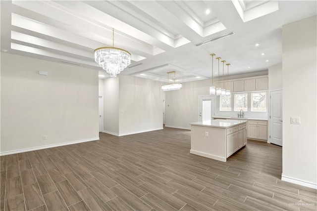 4312 Xenops Ave, Mcallen, TX 78503 - kitchen with a chandelier, wood finished floors, light countertops, a center island, and baseboards