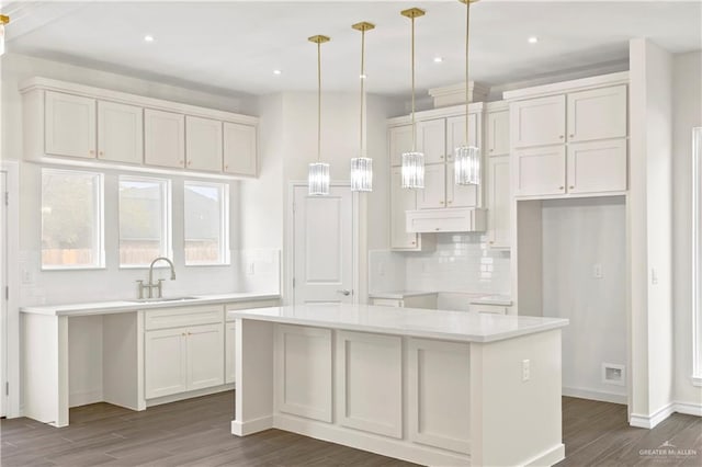 4312 Xenops Ave, Mcallen, TX 78503 - kitchen with a sink, dark wood-style floors, decorative backsplash, a kitchen island, and recessed lighting