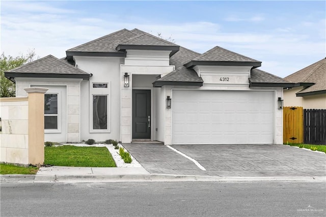 4312 Xenops Ave, Mcallen, TX 78503 - view of front facade featuring a shingled roof, a garage, driveway, and stucco siding