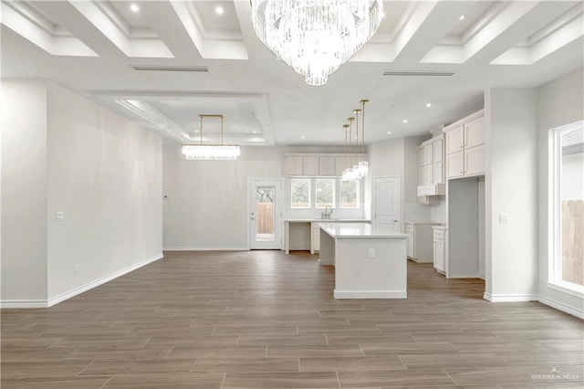4312 Xenops Ave, Mcallen, TX 78503 - kitchen with a chandelier, a kitchen island, recessed lighting, wood finished floors, and white cabinetry