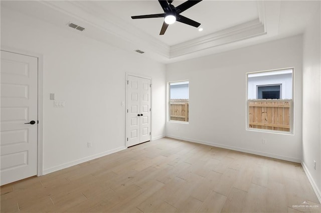 1305 Franklin Ave, Alton, TX 78573 - unfurnished bedroom featuring a raised ceiling, light wood-type flooring, crown molding, baseboards, and ceiling fan