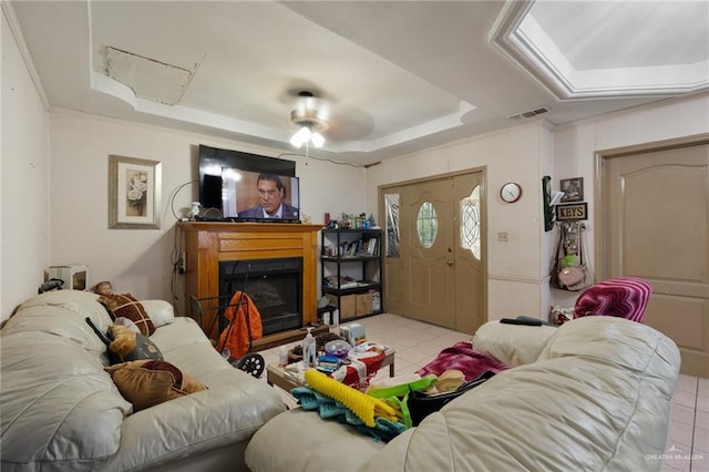 100 W Mesquite St, Sullivan City, TX 78595 - living area with visible vents, tile patterned floors, a tray ceiling, and a fireplace