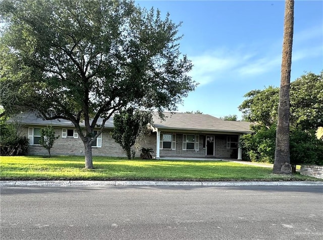 1108 Ash Dr, Weslaco, TX 78596 - ranch-style home featuring a front yard and brick siding