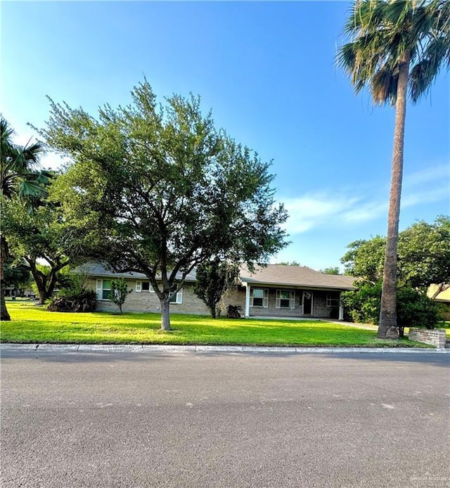 1108 Ash Dr, Weslaco, TX 78596 - view of front facade featuring a front yard