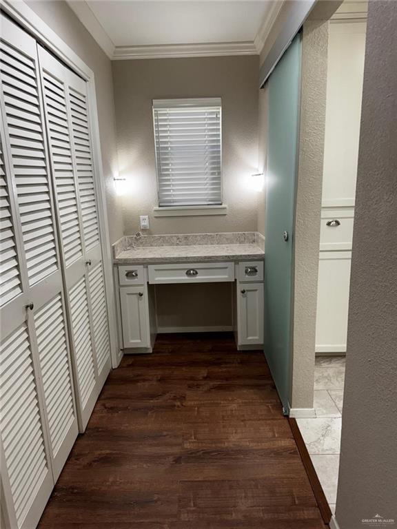 1108 Ash Dr, Weslaco, TX 78596 - corridor featuring ornamental molding, a desk, and dark wood-style flooring