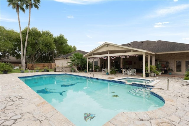 view of swimming pool with an in ground hot tub and a patio