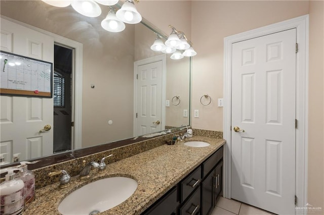 bathroom with tile patterned floors, vanity, and a chandelier