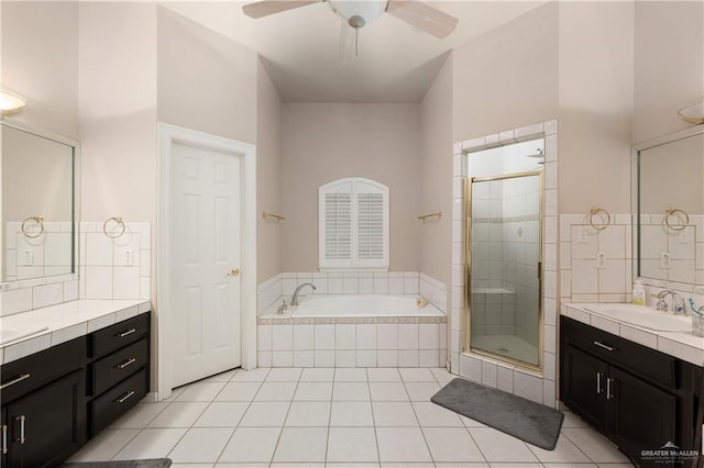 bathroom with tile patterned flooring, ceiling fan, vanity, and plus walk in shower