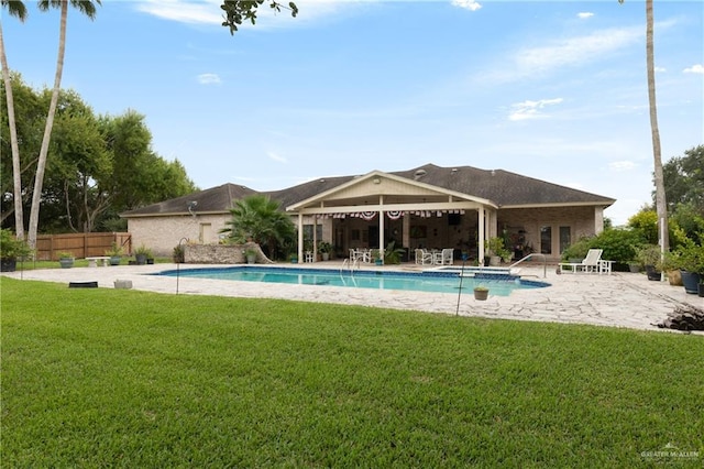 view of pool with a lawn and a patio area