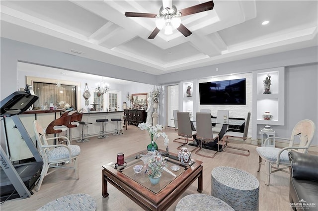 living room with beamed ceiling, coffered ceiling, and ceiling fan with notable chandelier