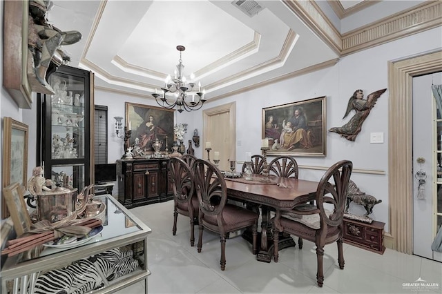 dining area with ornamental molding, an inviting chandelier, and a tray ceiling