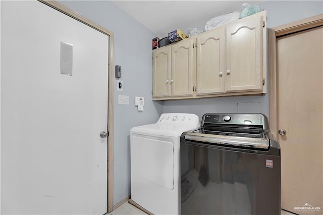 laundry area featuring cabinets and washer and clothes dryer