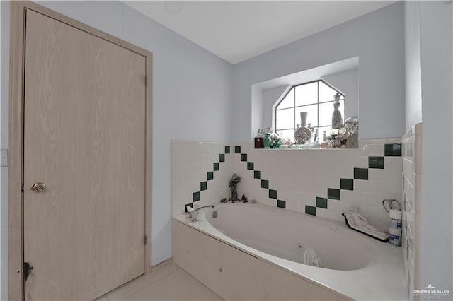 bathroom with tile patterned floors and a bathing tub