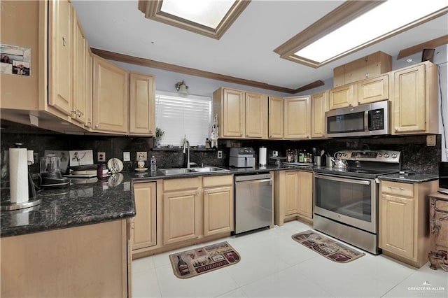 kitchen featuring dark stone countertops, sink, backsplash, and appliances with stainless steel finishes