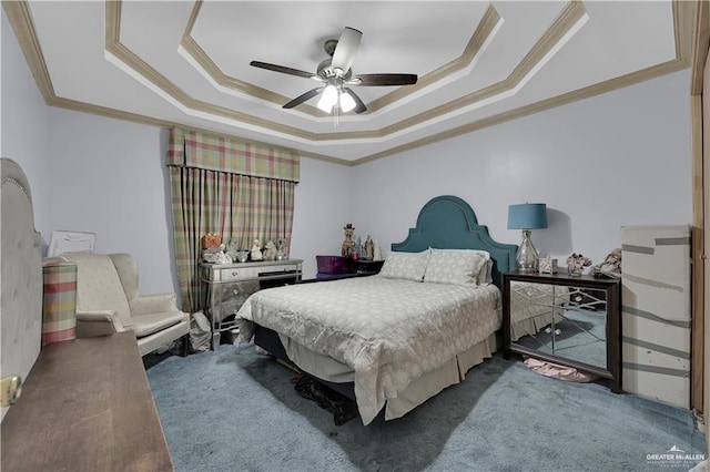 bedroom featuring ceiling fan, ornamental molding, and a tray ceiling