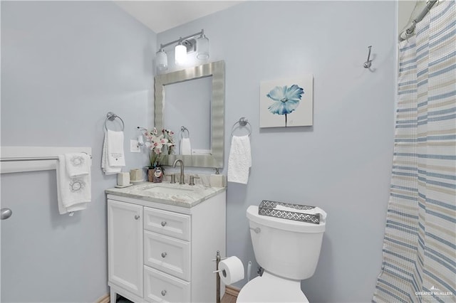 bathroom with vanity, a shower with curtain, and toilet