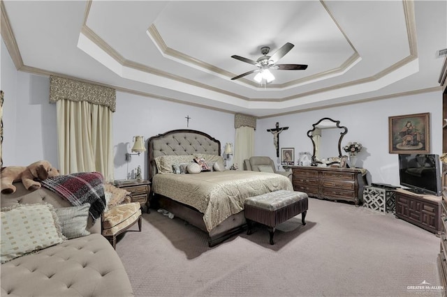 carpeted bedroom with crown molding, ceiling fan, and a tray ceiling