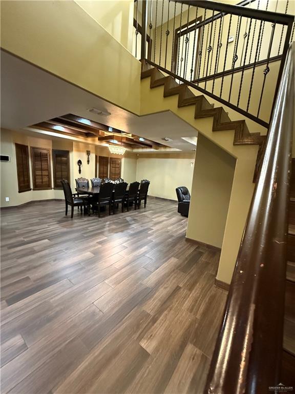 812 W Falcon Ave, Pharr, TX 78577 - dining room with a towering ceiling, wood finished floors, stairway, and baseboards