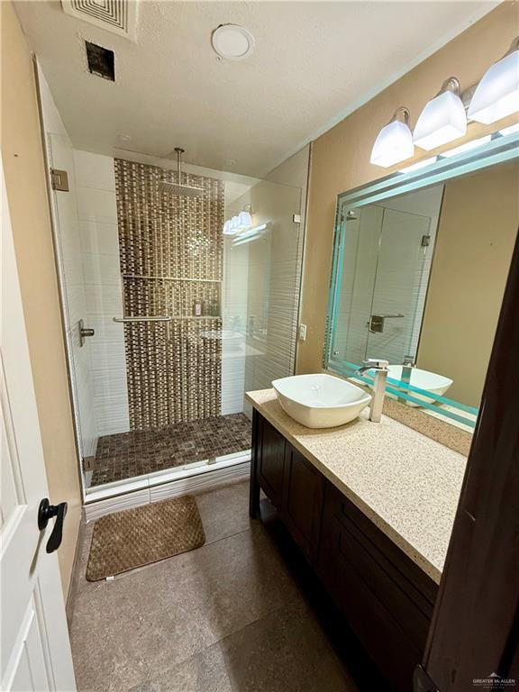 812 W Falcon Ave, Pharr, TX 78577 - bathroom with a shower stall and vanity
