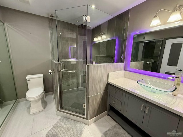 812 W Falcon Ave, Pharr, TX 78577 - full bathroom with vanity, toilet, a stall shower, tile patterned flooring, and baseboards