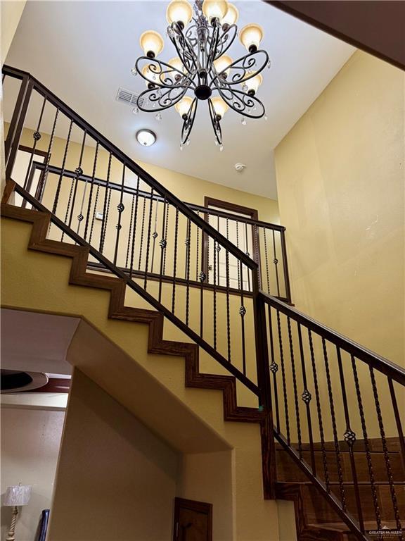 812 W Falcon Ave, Pharr, TX 78577 - staircase featuring a chandelier and a towering ceiling