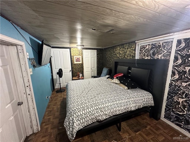 bedroom with dark parquet flooring and wood ceiling