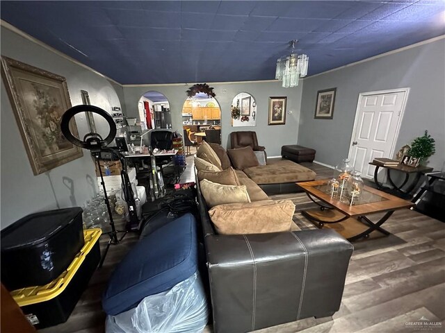 living room with hardwood / wood-style flooring and an inviting chandelier